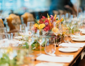 beautifully decorated long table with chairs ready for a event dinner