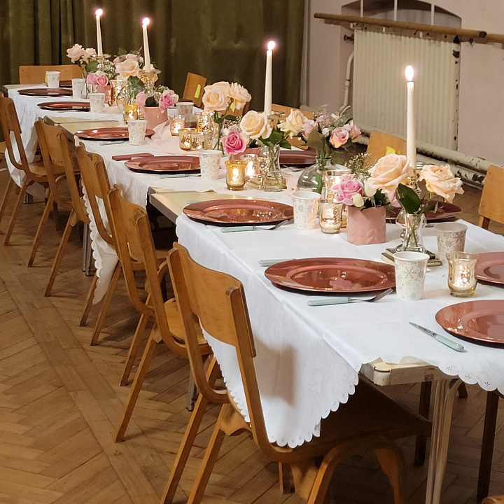 beautifully decorated long table with chairs ready for a event dinner